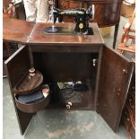 A Singer sewing machine and table, s/n EB801968