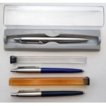 Three Parker ballpoint pens, all in Parker cases