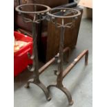 A pair of wrought iron brazier fire dogs, 62cmH, 45cm deep