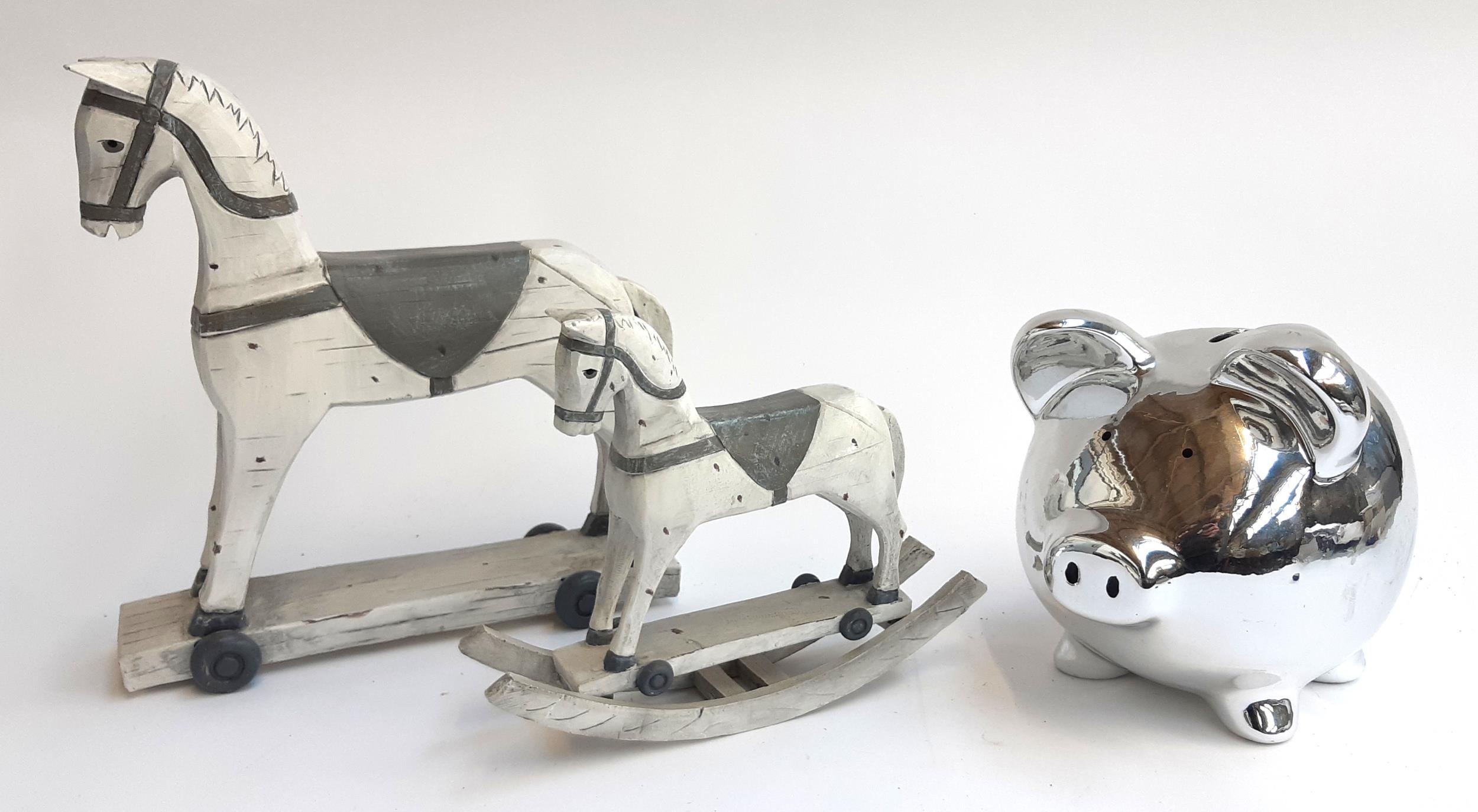 Two resin rocking horse figures, together with a large piggy bank, 19cmH