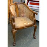 A carved and upholstered captains chair, with splatback, on pad feet, 60cmW