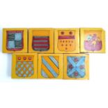Seven hand painted Spanish tiles with armorial crests, each 13cm square