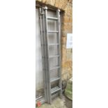 A Favorit three section extending aluminium ladder, each section with seven rungs, 5m total