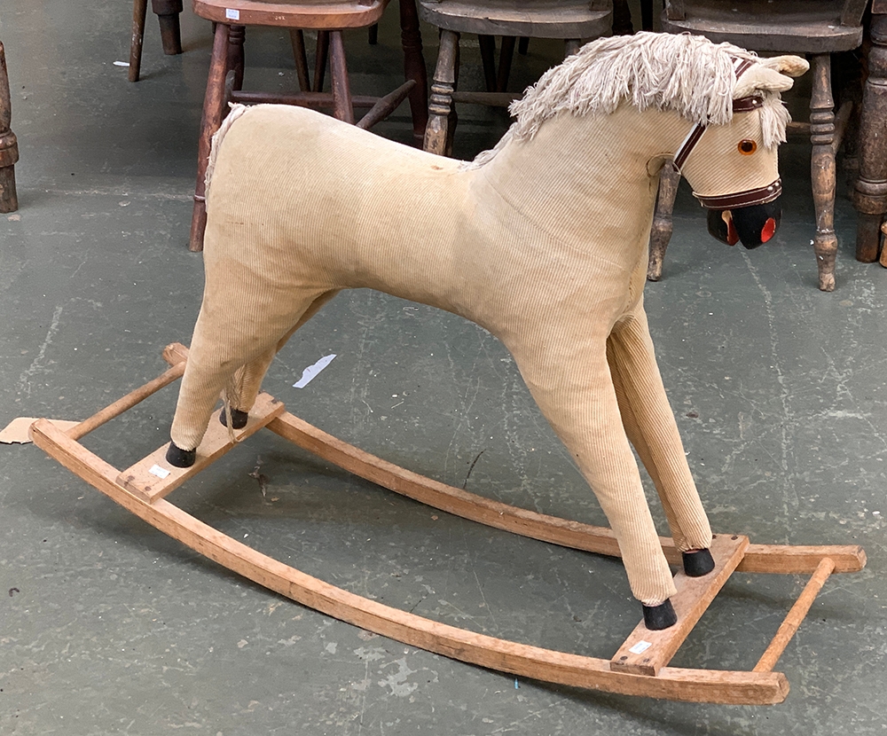 A rocking horse, upholstered in cord, on beech runners, 107cmL