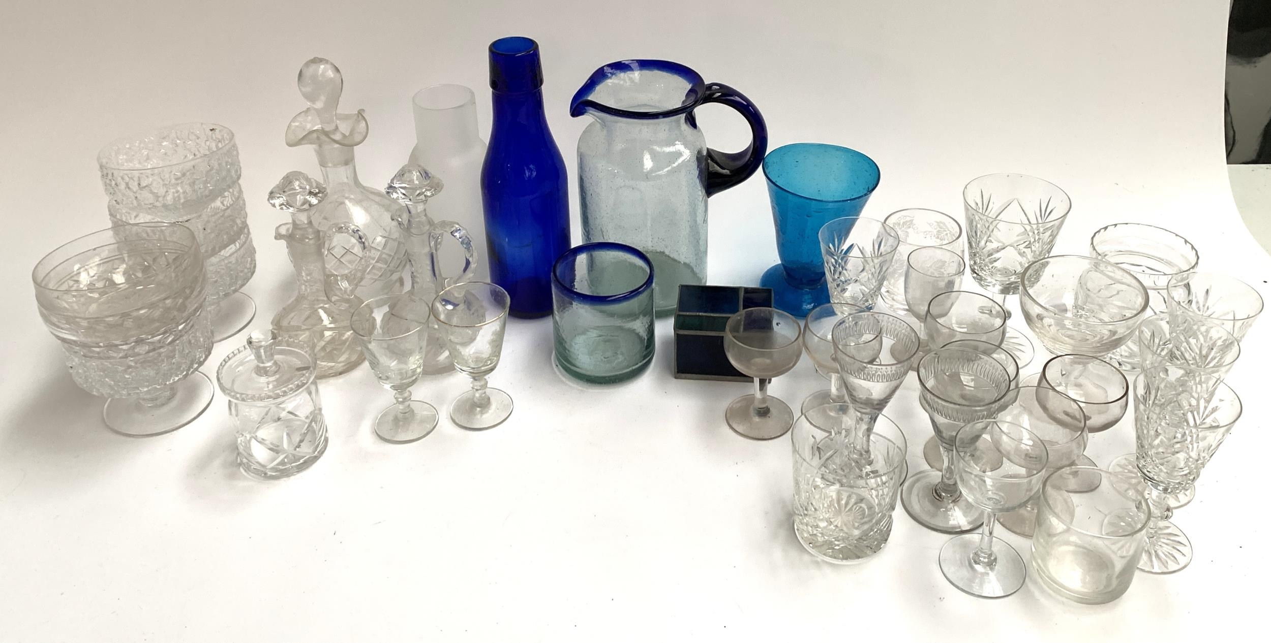 A mixed lot of glass and cut glass items to include studio glass water jug and cup, vinegar and
