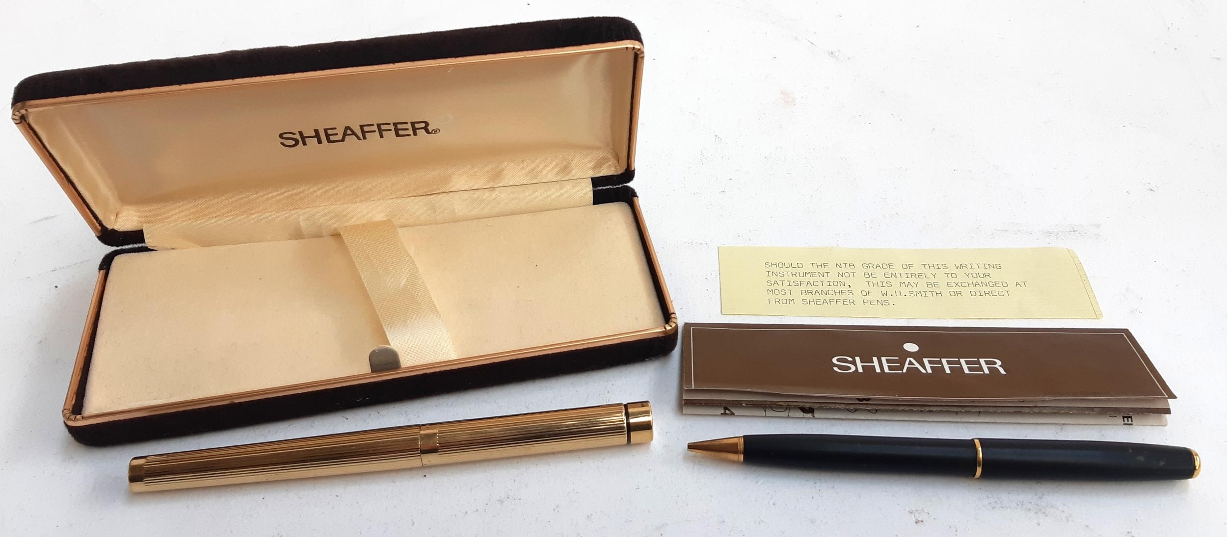 A gold plated Sheaffer fountain pen with 14ct nib and IBM logo to top, inscribed D.R. Coulson, in
