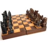 A Korean carved soap stone chess set, the king 10cmH, in a wooden case/board