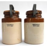 Two WWII stoneware ointment anti gas jars, 29cmH to top of handle