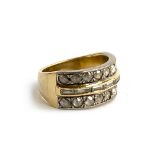 An 18ct gold ring, set with a central row of seven baguette cut diamonds, flanked by rows of nine