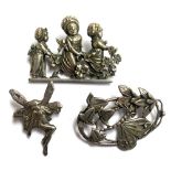 White metal Art Nouveau style brooch; together with a fairy brooch and a silver brooch depicting
