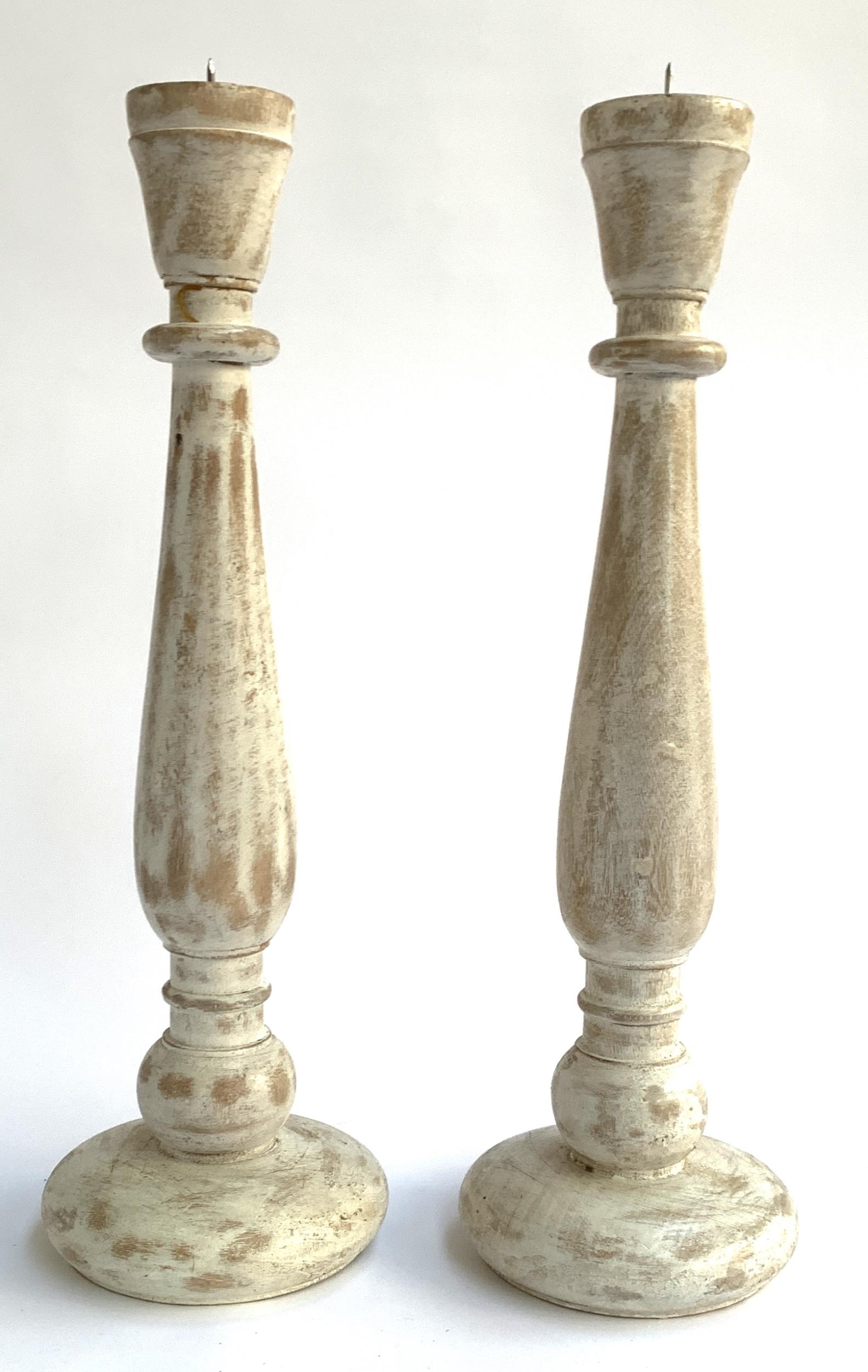 A pair of large wooden candlesticks, each 45.5cmH