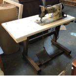 A Singer sewing machine and table, extremely heavy, with accessories, serial no. 111W151