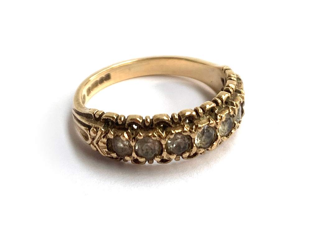 An ornate 9ct gold half eternity band set with white stones, approx. 2.7g, size L