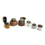 A collection of various ink wells, to include a leather covered travelling inkwell with glass