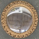 A gilt framed convex circular mirror, with pierced frame, 47cmD