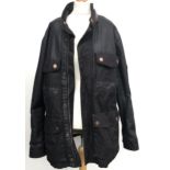 A Timberland Earthkeepers size XL heavy black canvas jacket with fleece lining and leather trim