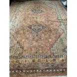 A large orange ground Persian rug, 3 central hooked lozenges, 440x300cm