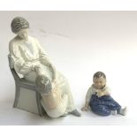 A Royal Copenhagen baby figurine number 156 together with a Bing & Grondhahl mother & baby figurine