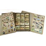 Three scrapbooks containing a quantity of cigarette cards to include, Ogdens, Gallaher, Players,