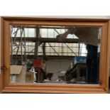 A rectangular pine framed wall mirror with bevelled glass, 77x53cm