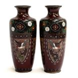 A pair of Japanese Meiji era cloisonne vases, decorated with panels of birds and dragons, each 19cmH