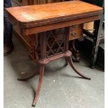 A 20th century tea table, fold over swivel top on two reeded columns and four swept legs with