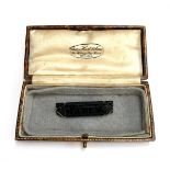 A 19th century carved jet mourning brooch reading 'Faney', 4.5cmL, in a brown leather box