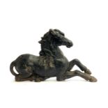 A cast iron unicorn fire dog (horn missing), 61cmL