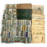A large quantity of cigarette cards, many in Players and Wills packets, some stuck in albums to