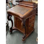 A 19th century walnut davenport, superstructure with fitted interior to include two inkwells, sloped