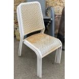 A set of four white metal stacking garden chairs