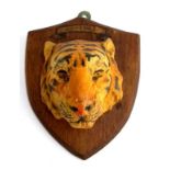 A 'Whipsnade' tiger mask mounted to an oak plaque, 13cmL