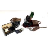 A Kodak kodon bellows camera, a ensign ful-view camera, a pair of Noctovist 8x30 binoculars,