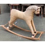 A rocking horse, upholstered in cord, on beech runners, 107cmL