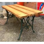 A garden table, plank top on cast iron base, 126x66x69cmH