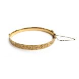 A LW&G Lagarmic 9ct gold with bronze core bangle, foliate design, approx. 6.5cm wide, with safety