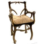 An unusual armchair, cast resin in the form of antlers, wooden slab seat with squab cushion