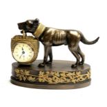 A Regency style resin clock in the form of a dog holding a basket, 20cmH 25cmL