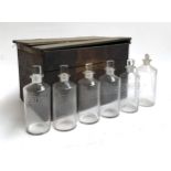 A set of 5 apothecary bottles, etched for different acids, together with one other plain bottle,