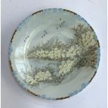 A Japanese hand painted plate depicting Mt. Fuji, marks to base, 23.5cmD