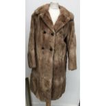 A 1960s ladies double breasted fur coat, size 10, together with a further ladies fur coat