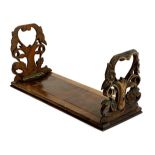 A 19th century rosewood travelling/sliding book stand with foliate carved ends, 36-60cmW