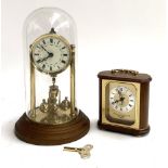 A gilt metal skeleton clock, painted dial with Roman numerals, glass dome with key, 31cmH,