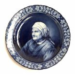 A large Delft charger by Franz Anton Mehlem, decorated with an image of old woman by Dingendorf,