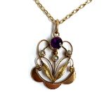 An Art Nouveau 9ct gold pendant set with an amethyst and three seed pearls, hallmarked H&W, 2.5cm