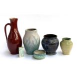 A red glazed Austrian ewer, a Bourne Denby vase, two studio pottery vases incised D.E to base, one