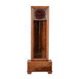 A German walnut Art Deco style quarter chiming longcase clock, the mock red marble dial with cut-
