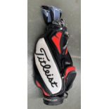 A Titleist golf bag containing a quantity of Dunlop and drivers clubs