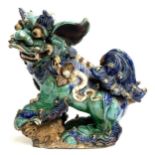 A large Chinese 19th century Sancai glazed foo dog (af), modelled with paw resting on puppy, 45cm