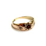 A 9ct gold gypsy ring set with diamond chips and a garnet, size P, 2.4g